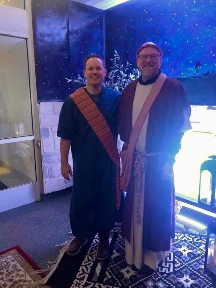 Two smiling volunteers in costume.